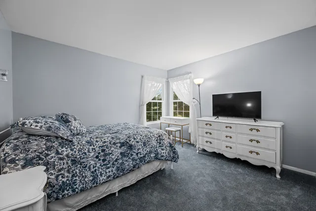 a bedroom with a bed and flat screen tv