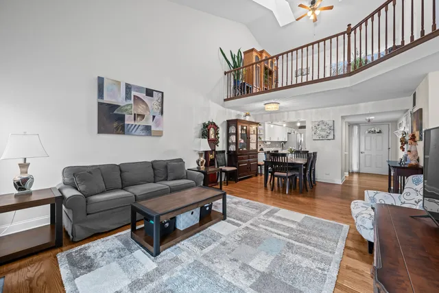 a living room with furniture and a ceiling fan