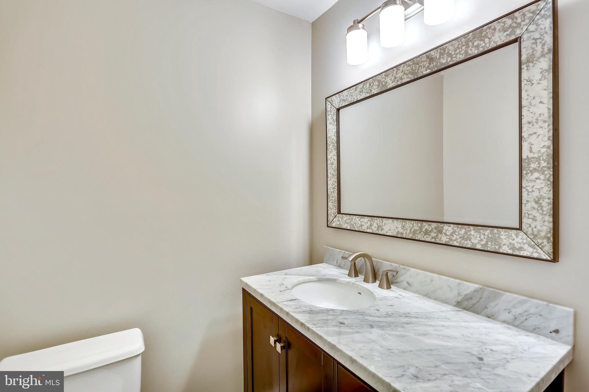 129 Summit Hall Road Gaithersburg, MD 20877 - Photo 8 of 48 Powder room w/ stained vanity and marble top