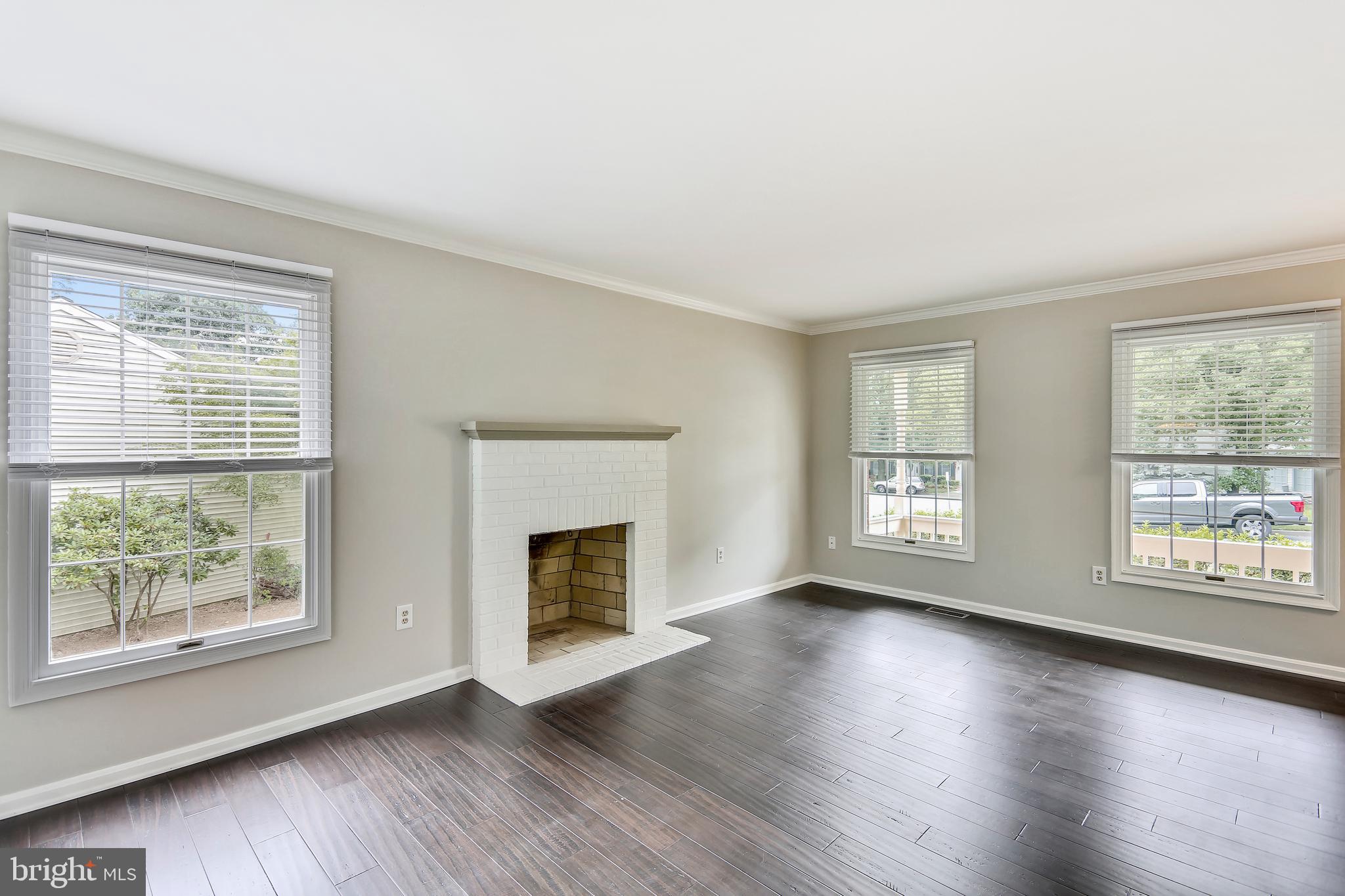 129 Summit Hall Road Gaithersburg, MD 20877 - Photo 10 of 48 Living room w/ crown moulding and wood burning FP