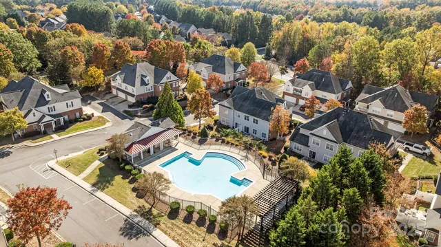 an aerial view of residential house with outdoor space and swimming pool