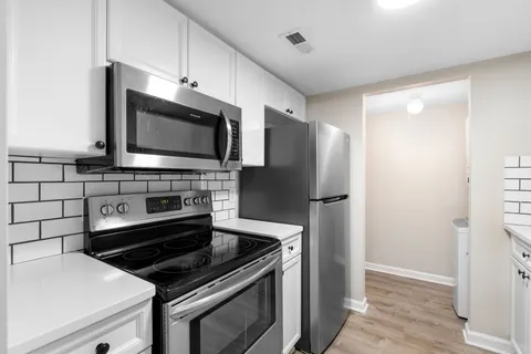 a kitchen with stainless steel appliances and granite countertop a stove top oven
