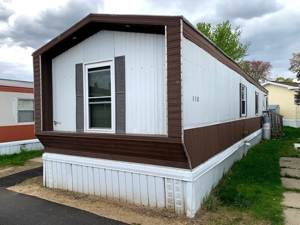 557 Southwest Cutoff, Unit 110 Worcester, MA 01607 - Photo 1 of 8 a front view of a house with yard
