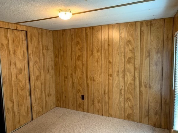 557 Southwest Cutoff, Unit 110 Worcester, MA 01607 - Photo 8 of 8 a view of a closet with wooden walls