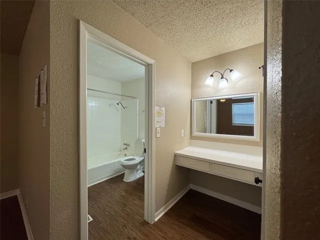 a view of bathroom with a toilet a sink and a mirror