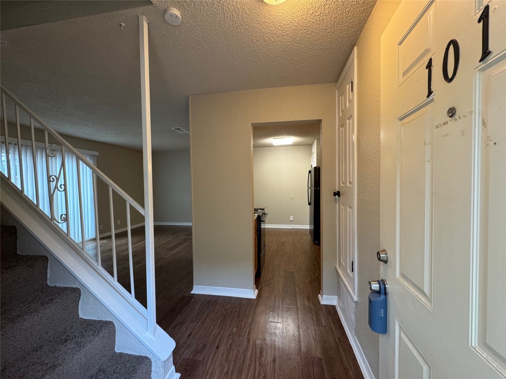 5006 West Wind Trail, Unit 101 Austin, TX 78745 - Photo 2 of 18 a view of entryway with wooden floor
