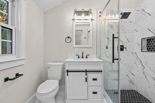 a bathroom with a sink toilet and shower