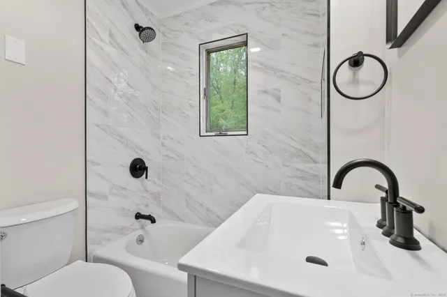 a bathroom with a sink a toilet and a tub