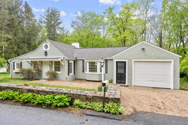 a front view of a house with a garden