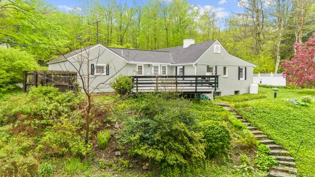 an aerial view of a house with yard swimming pool and outdoor seating