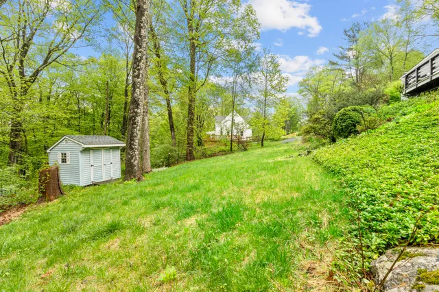 an aerial view of a house with a garden and swimming pool