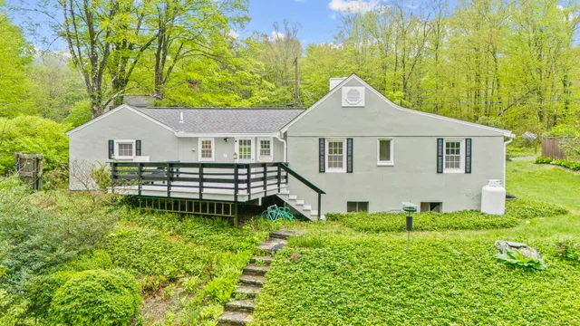 a house with green field in front of it