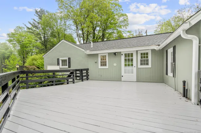 a view of a house with a yard and potted plants