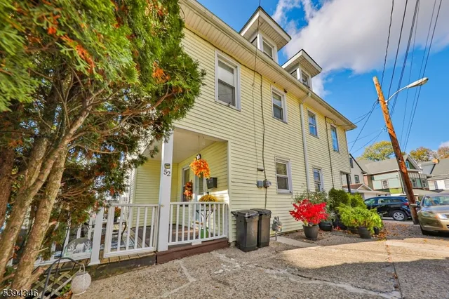 a view of a street with potted plants