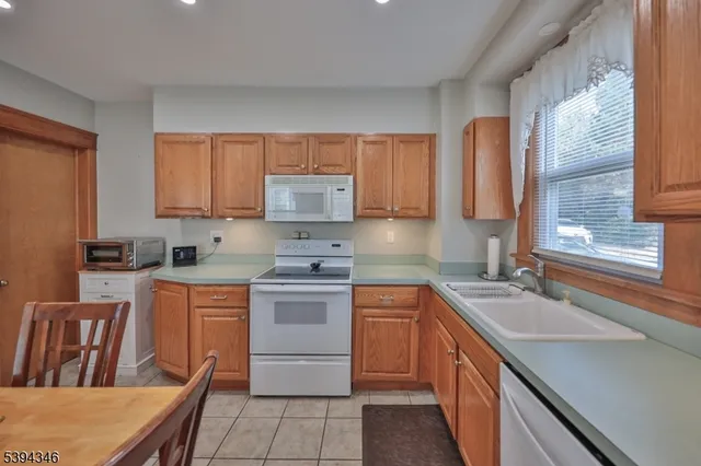 a kitchen with a sink stove top oven and cabinets