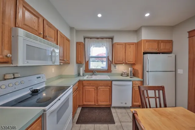 a kitchen with a sink stove and refrigerator