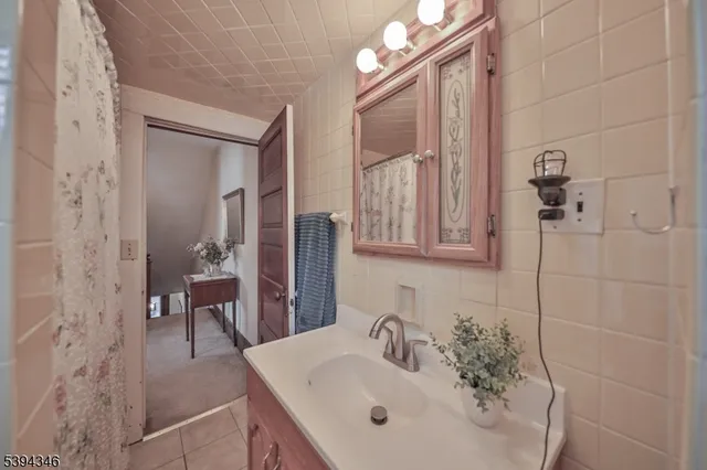 a bedroom with a bed and large windows