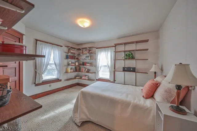 a bedroom with a bed and a view of kitchen
