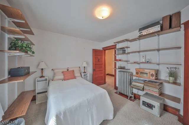 a bedroom with a bed and flat screen tv