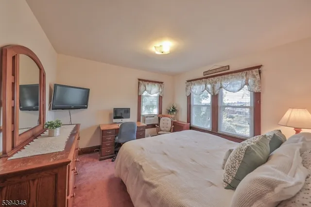 a bedroom with a large bed and a large window