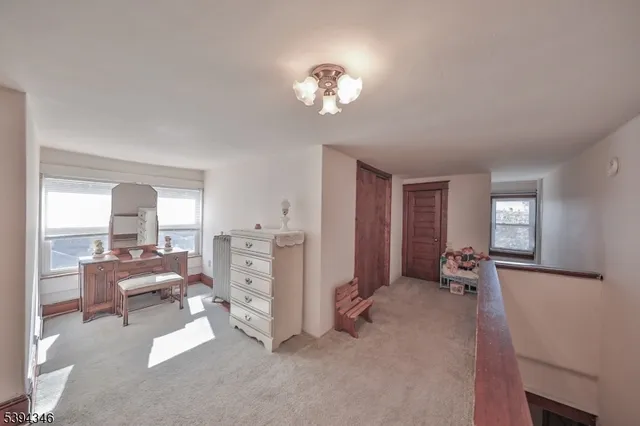 a view of a livingroom with wooden floor and a sink