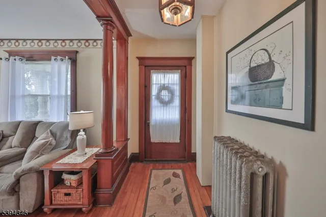 a view of a bedroom with furniture and wooden floor