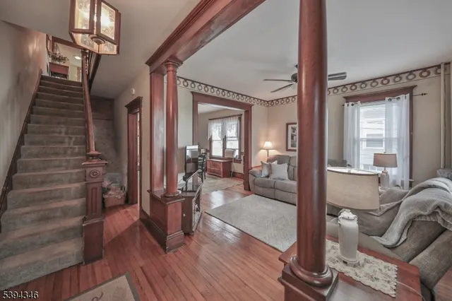 a view of a livingroom with furniture and hardwood floor