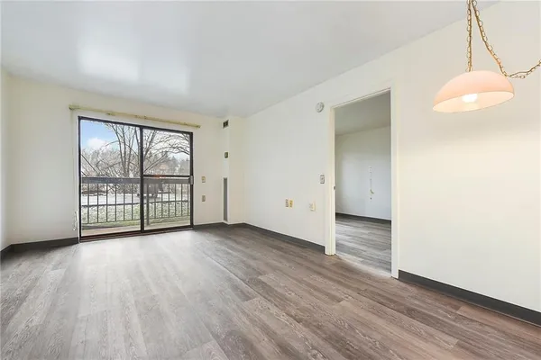 a view of a room with wooden floor and iron gate