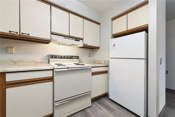 a kitchen with stainless steel appliances a refrigerator and cabinets