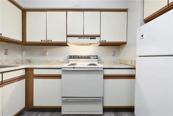 a kitchen with appliances cabinets and a sink