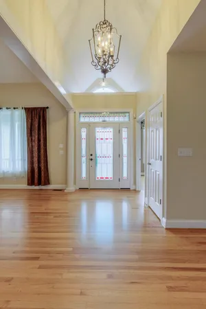 a view of a dining room with furniture and chandelier