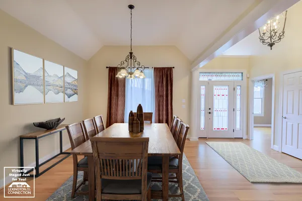 a view of an empty room with wooden floor fireplace and a window