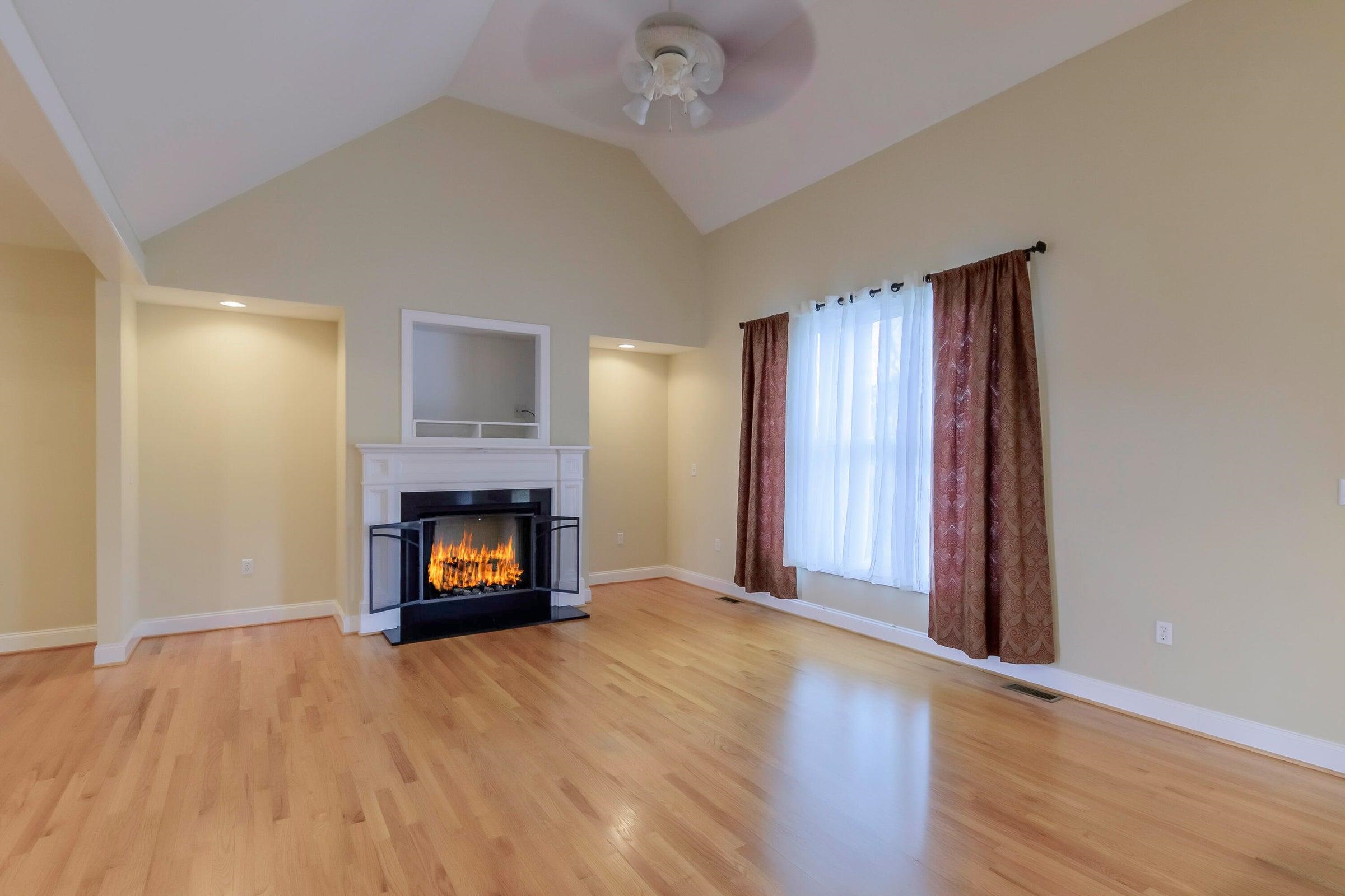 120 Springridge Lane Fairfield, VA 24435 - Photo 15 of 56 a view of an empty room with wooden floor fireplace and a window