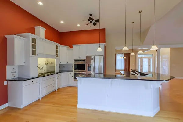 a kitchen with stainless steel appliances a refrigerator and a stove top oven