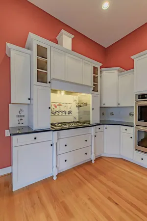 a kitchen with stainless steel appliances granite countertop a sink a stove and a refrigerator