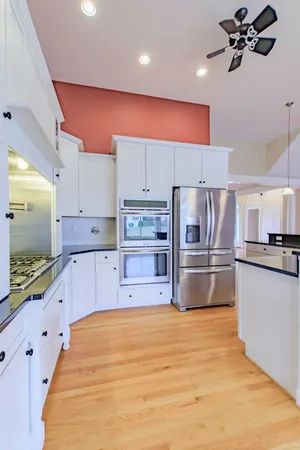a kitchen with kitchen island a counter a sink and a refrigerator
