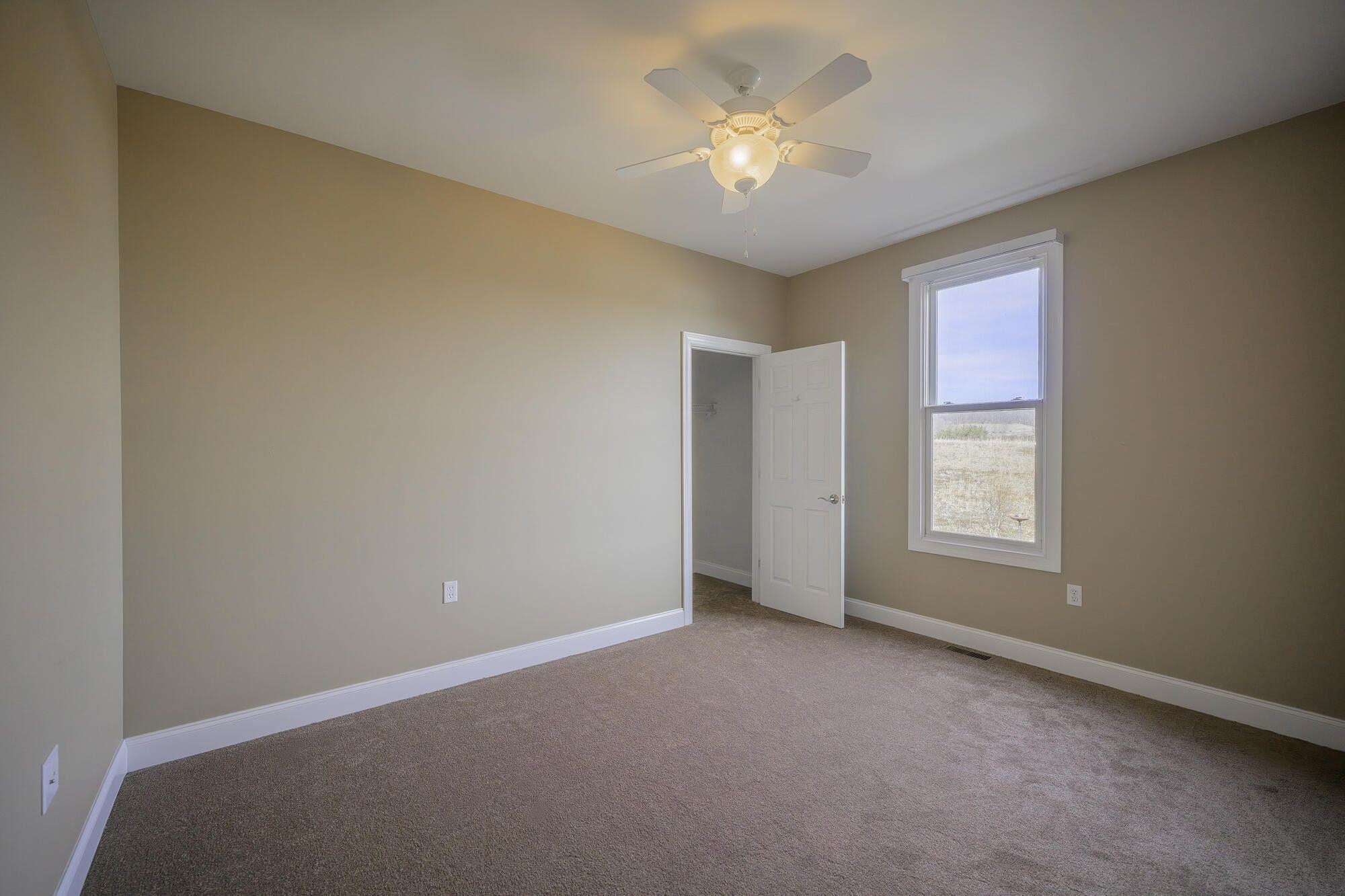 120 Springridge Lane Fairfield, VA 24435 - Photo 40 of 56 an empty room with a chandelier fan and windows