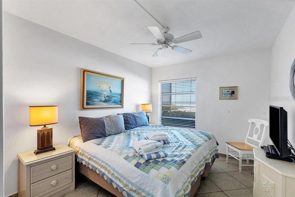 6154 Midnight Pass Road, Unit 101 Sarasota, FL 34242 - Photo 5 of 10 a bedroom with a bed and furniture
