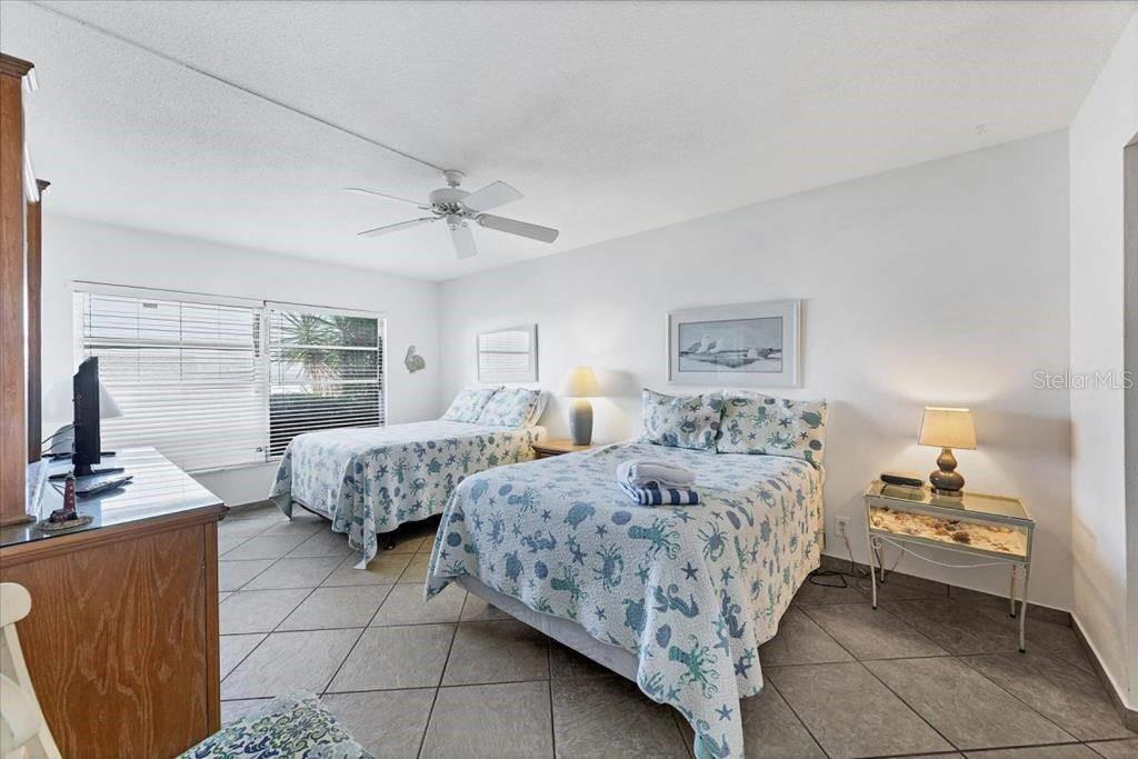 6154 Midnight Pass Road, Unit 101 Sarasota, FL 34242 - Photo 6 of 10 a room with two bed and a window