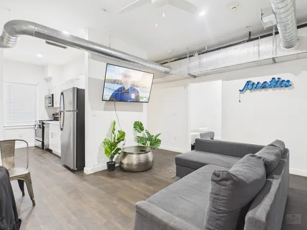 a living room with furniture and painting on the wall