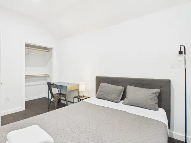 a bedroom with a bed and a chair