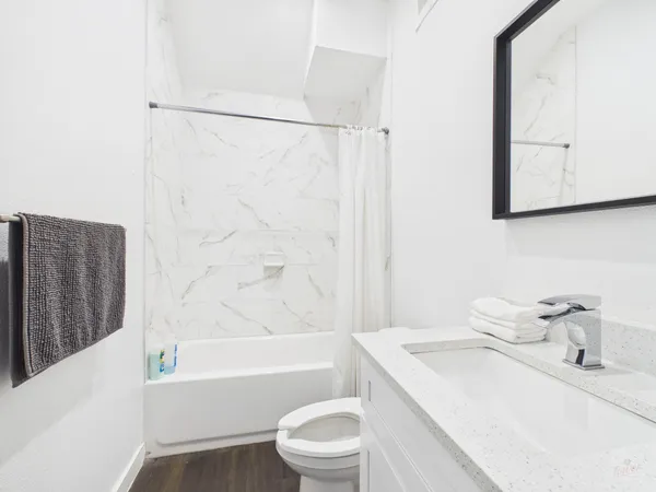 a bathroom with a sink toilet and shower