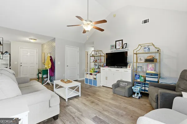 a living room with furniture and a flat screen tv
