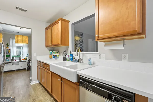 a kitchen with a sink appliances and cabinets
