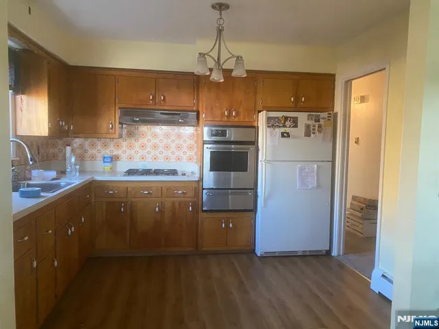 a kitchen with refrigerator and cabinets
