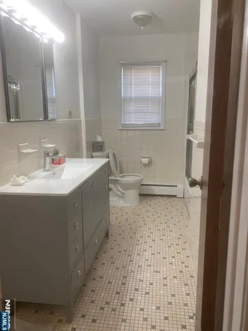 a bathroom with a sink a toilet and mirror