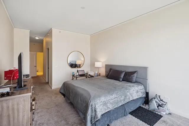 a bathroom with a granite countertop sink a toilet and a mirror
