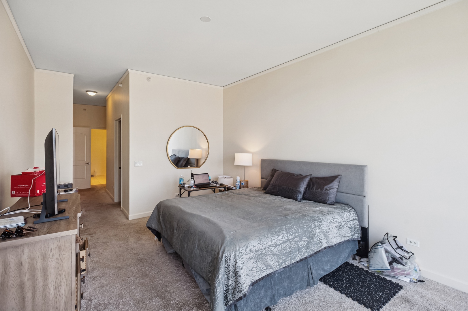 450 East Waterside Drive, Unit 2902 Chicago, IL 60601 - Photo 12 of 44 a bedroom with a bed and a dresser