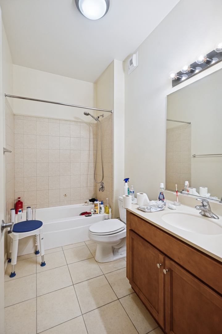 450 East Waterside Drive, Unit 2902 Chicago, IL 60601 - Photo 15 of 44 a bathroom with a sink toilet and shower
