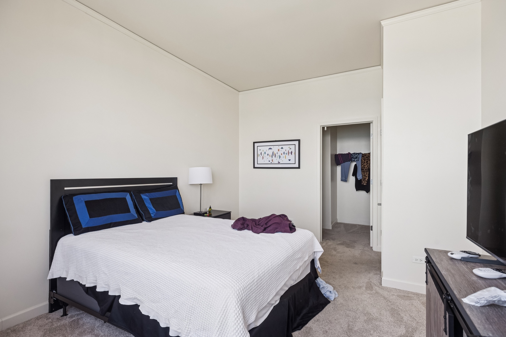 450 East Waterside Drive, Unit 2902 Chicago, IL 60601 - Photo 17 of 44 a bedroom with a bed and a flat screen tv